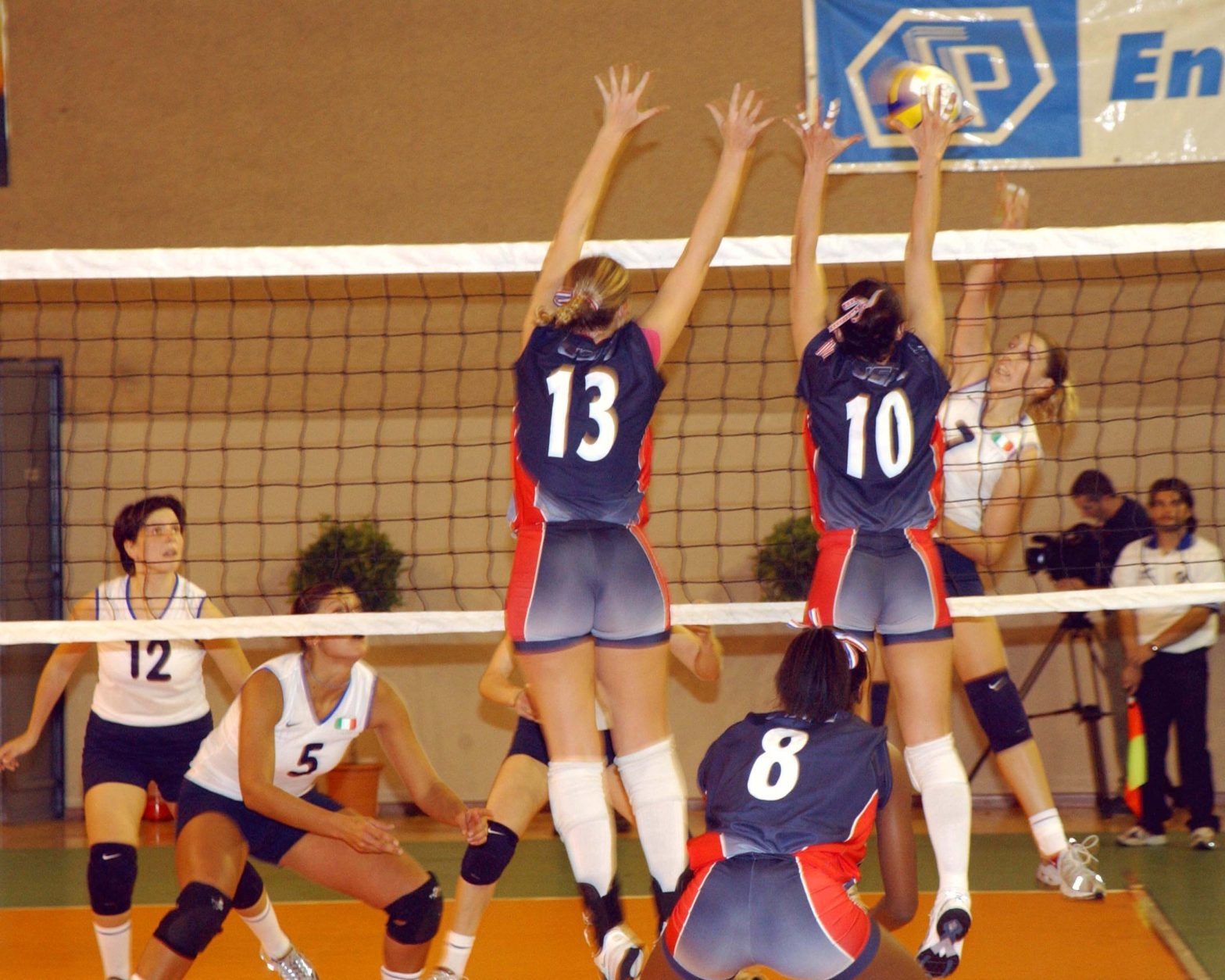 A group of women playing volleyball on a court.