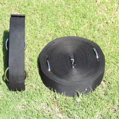 A black strap sitting on top of grass.
