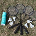 A group of badminton rackets and some shuttlecocks.