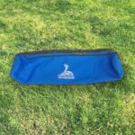 A blue bag sitting on top of grass.