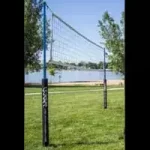 A volleyball net in the middle of a field.