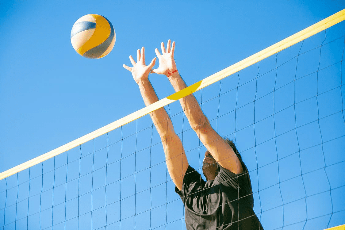 A person jumping to block a ball.