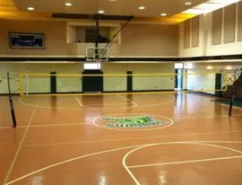 A basketball court with a large window in the middle.