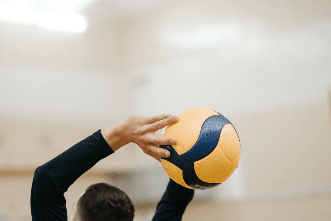 a person throwing a volleyball