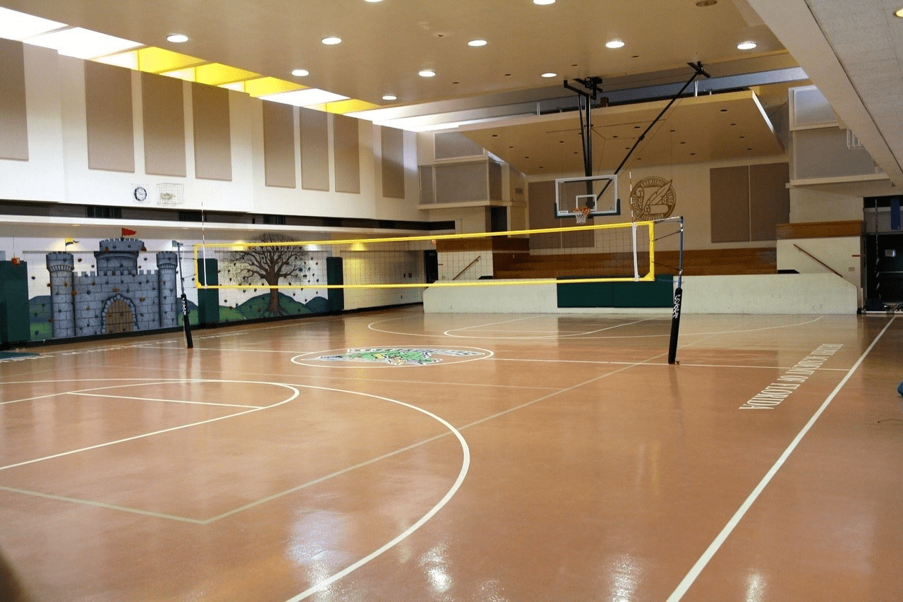 A basketball court with a net and a ball.