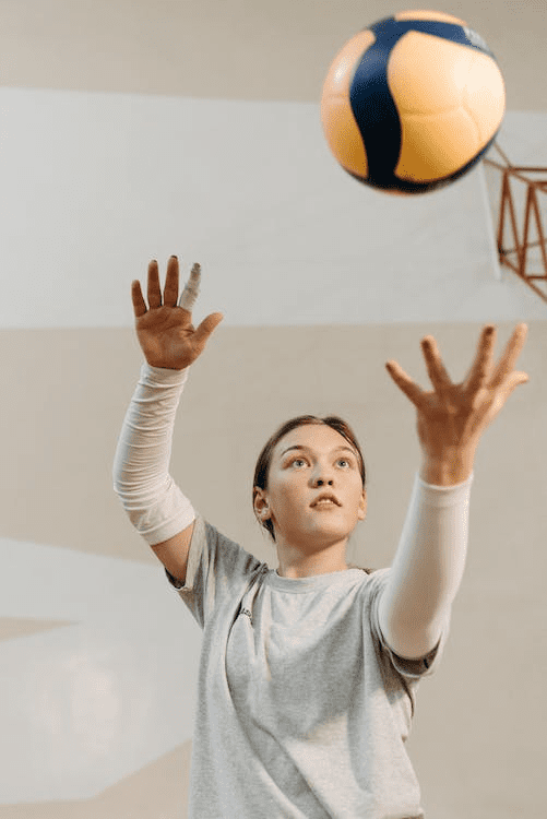 a woman playing with volleyball